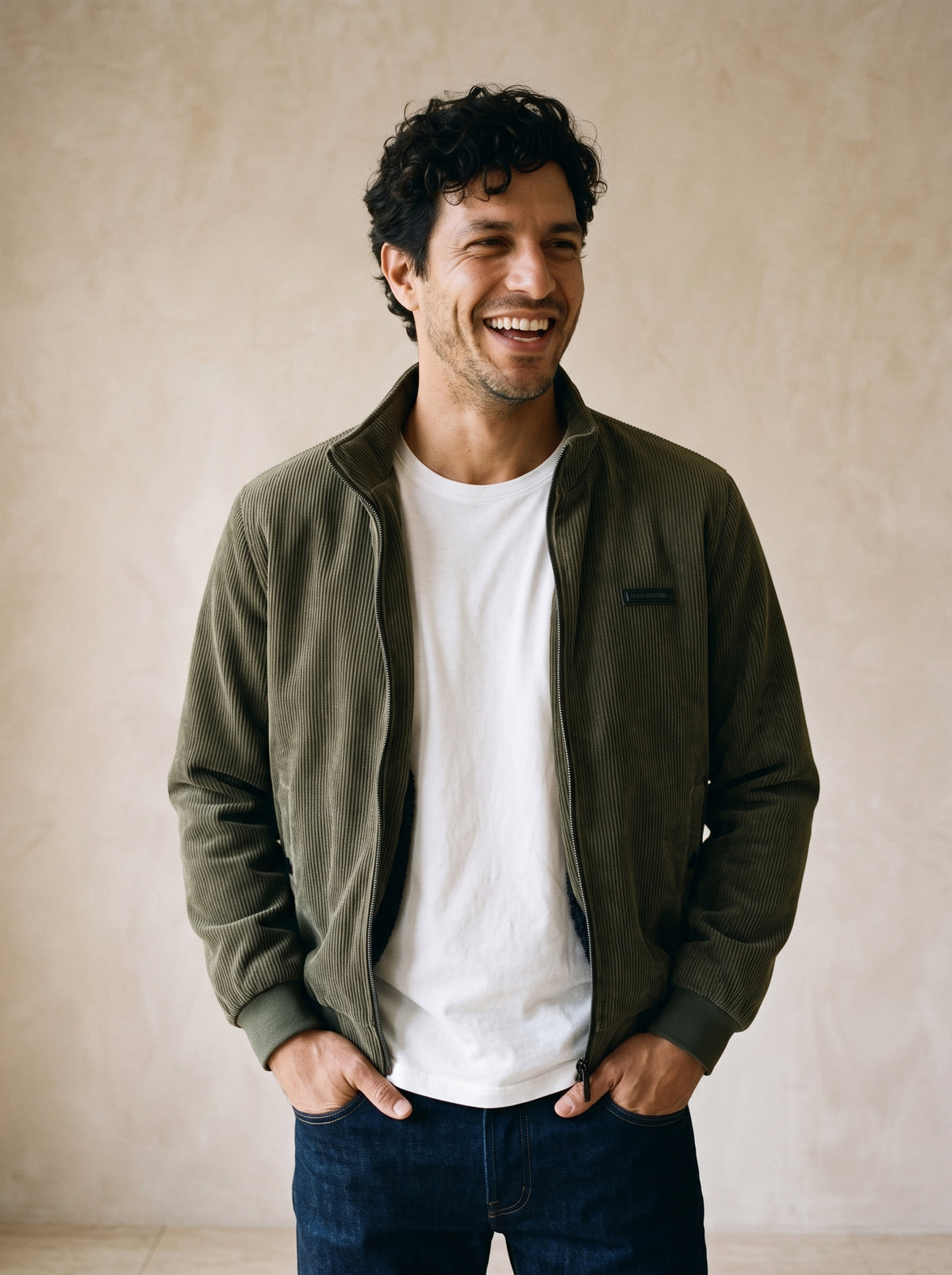Verde-escuro | Jaqueta aveludada Piran verde-escuro – modelo sorrindo, recorte médio